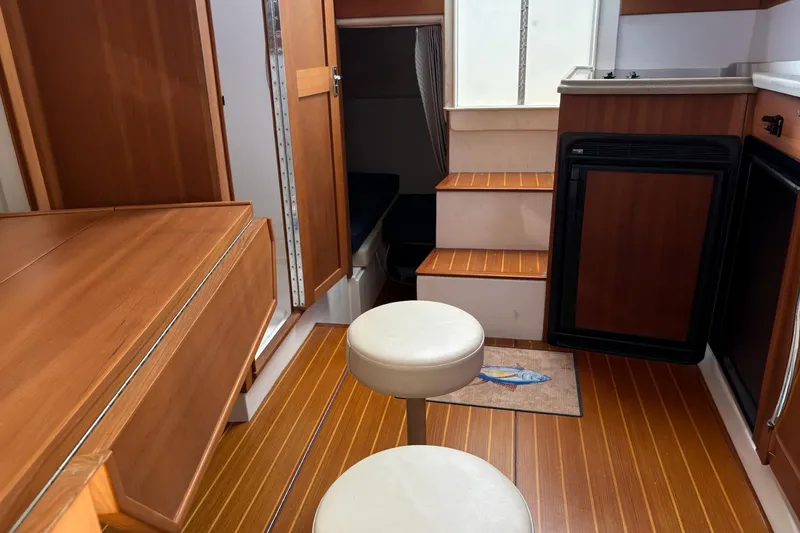 Slide: The Image of Interior of 2008 Stamas 370 Express boat with wooden cabinetry and seating. - 12