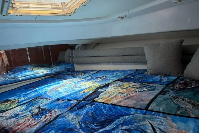 Slide: The Image of Interior cabin of 2008 Stamas 370 Express with vibrant marine-themed bedding. - 14