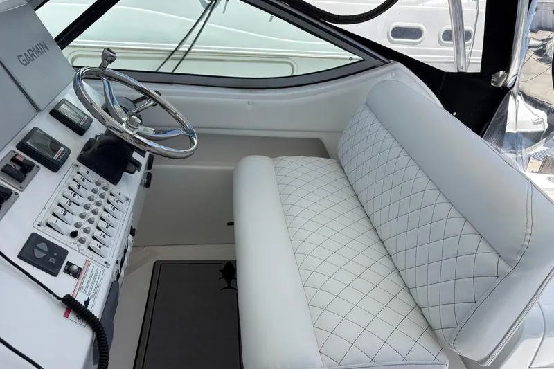 Slide: The Image of 2008 Stamas 370 Express helm with white quilted seating and Garmin navigation system. - 18