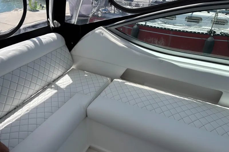 Slide: The Image of Luxurious white seating inside a 2008 Stamas 370 Express boat, featuring diamond stitching. - 19