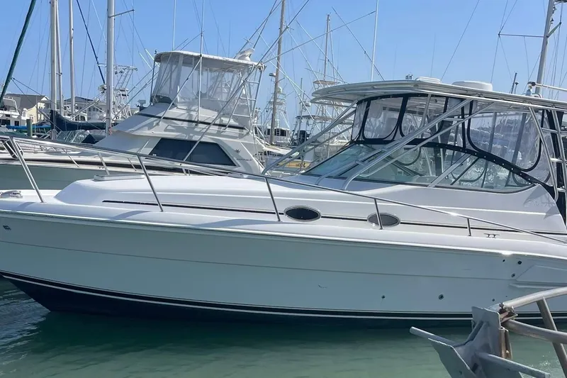 Slide: The Image of 2008 Stamas 370 Express boat docked in a marina under clear blue skies. - 2
