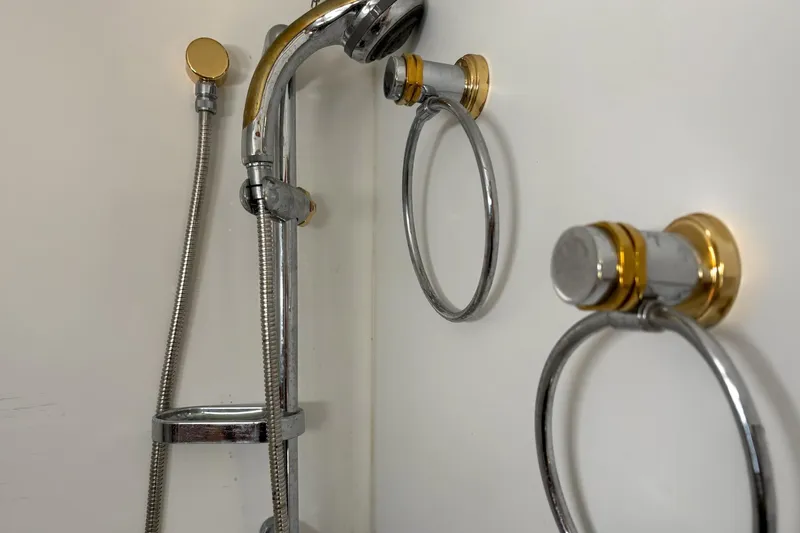 Slide: The Image of Shower fixtures with chrome and gold accents on a 2008 Stamas 370 Express boat. - 9