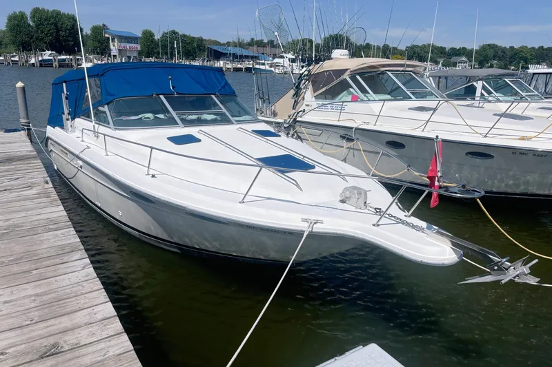 The Image of 1992 Sea Ray 300 Weekender boat docked at marina with blue canopy. - 0