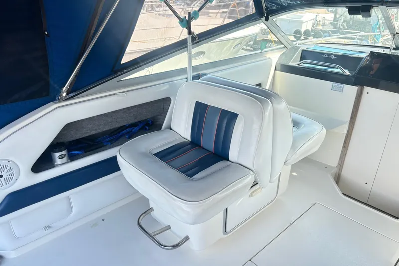 Slide: The Image of Interior of a 1992 Sea Ray 300 Weekender boat with white and blue seating. - 11