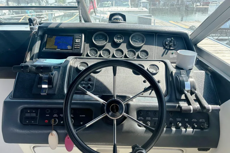 Slide: The Image of Control panel of a 1992 Sea Ray 300 Weekender boat with steering wheel and gauges. - 14