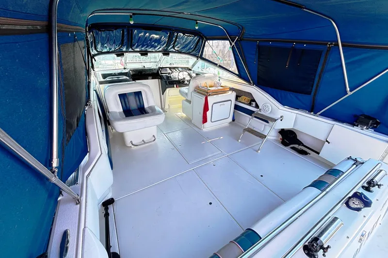 Slide: The Image of Interior of a 1992 Sea Ray 300 Weekender boat with blue canopy and seating. - 8