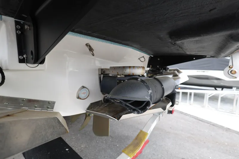 Slide: The Image of 2023 MasterCraft X24 boat underside showing exhaust and propeller components. - 10