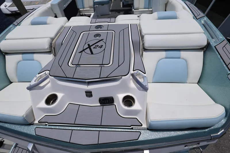Slide: The Image of 2023 MasterCraft X24 boat interior with luxurious seating and sleek design. - 14