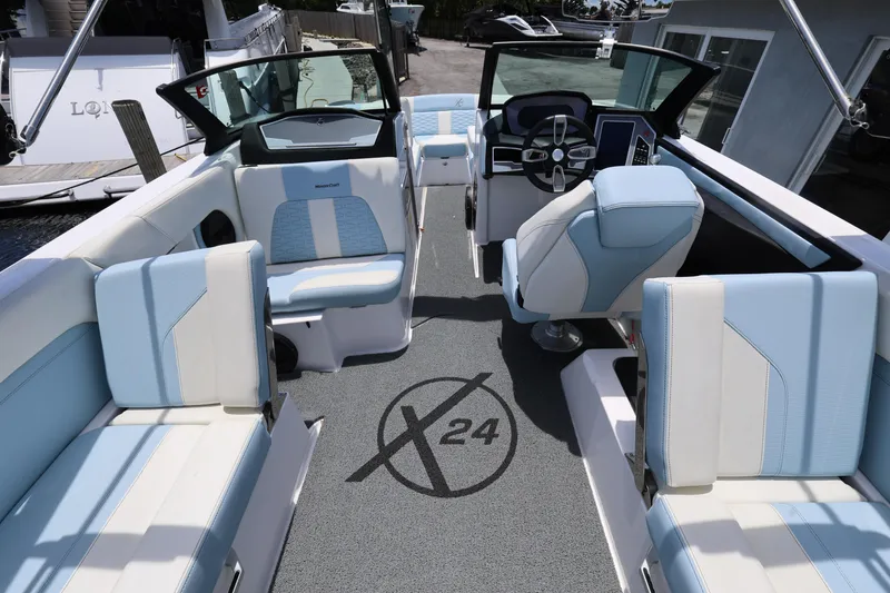 Slide: The Image of 2023 MasterCraft X24 boat interior with modern seating and steering, showcasing luxury design. - 16