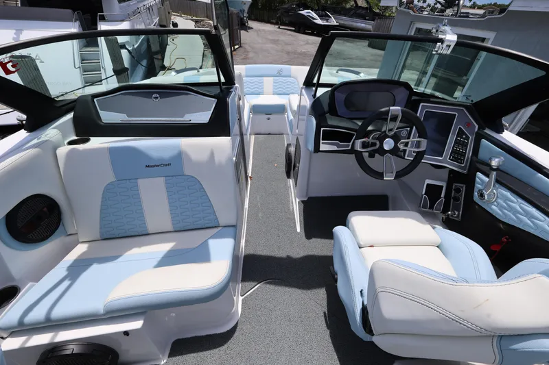 Slide: The Image of 2023 MasterCraft X24 boat interior with modern dashboard and seating. - 17