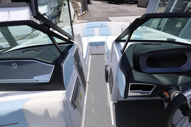 Slide: The Image of 2023 MasterCraft X24 boat interior with modern dashboard and seating. - 19
