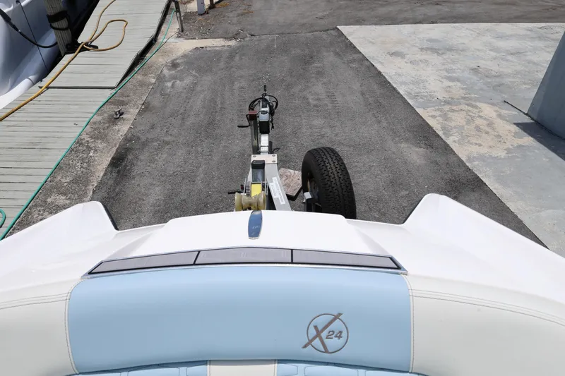 Slide: The Image of 2023 MasterCraft X24 boat on trailer at dockside, rear view. - 23