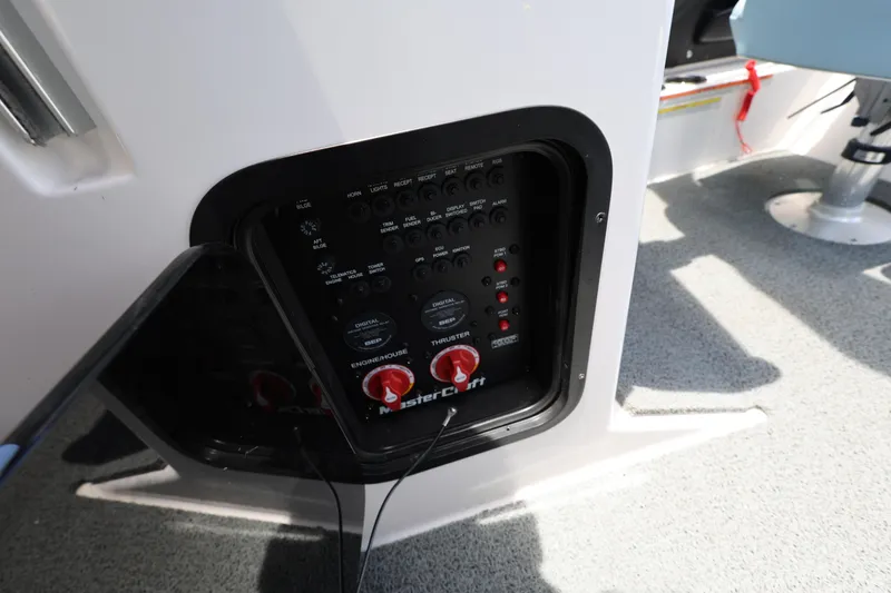 Slide: The Image of Control panel of 2023 MasterCraft X24 boat, featuring switches and dials. - 24