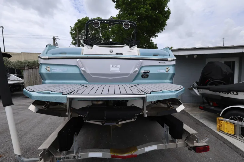 Slide: The Image of 2023 MasterCraft X24 boat on trailer, rear view, showcasing sleek design and modern features. - 4