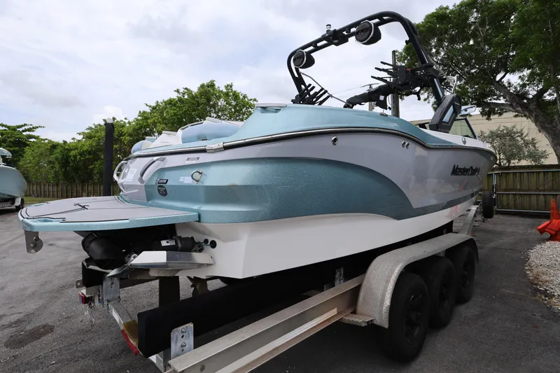 Slide: The Image of 2023 MasterCraft X24 boat on trailer, showcasing sleek design and modern features. - 5