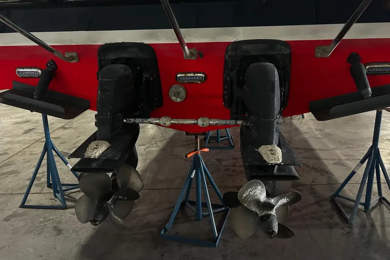 Slide: The Image of 2009 Vicem Windsor Craft 36 Hardtop boat propellers on stands in a garage. - 4