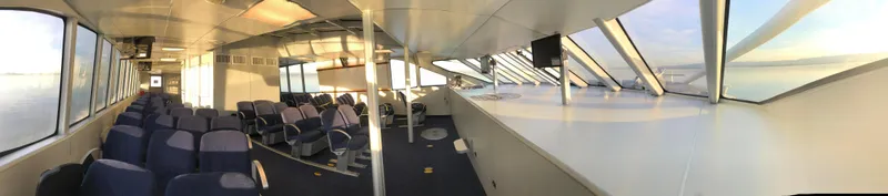 Slide: The Image of Interior of 2008 Custom High Speed 70pax COI Passenger vessel, featuring spacious seating and panoramic windows. - 18