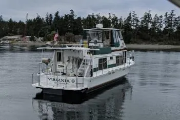 Slide: The Image of 1983 Uniflite Cabin Cruiser on calm water near forested shoreline. - 1