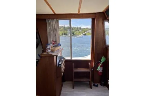 Slide: The Image of 1983 Uniflite Cabin Cruiser interior with lake view through window. - 12