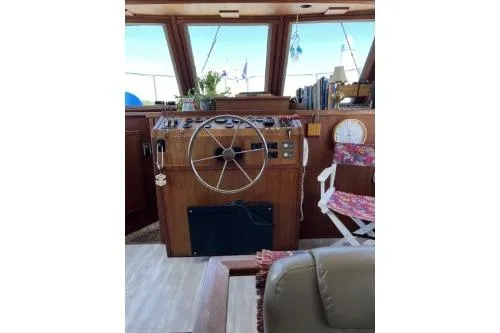 Slide: The Image of 1983 Uniflite Cabin Cruiser helm with wooden dashboard and steering wheel. - 5