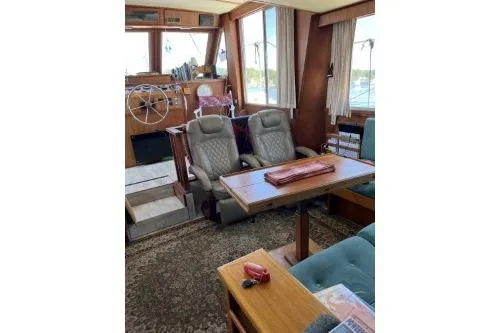 Slide: The Image of 1983 Uniflite Cabin Cruiser interior with helm, seating, and table. - 6