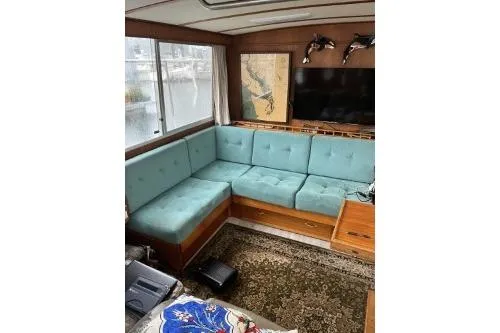 Slide: The Image of 1983 Uniflite Cabin Cruiser interior with teal seating and nautical decor. - 8