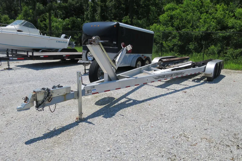 Slide: The Image of 2016 Regulator 28 boat trailer on gravel lot, with trees in background. - 22