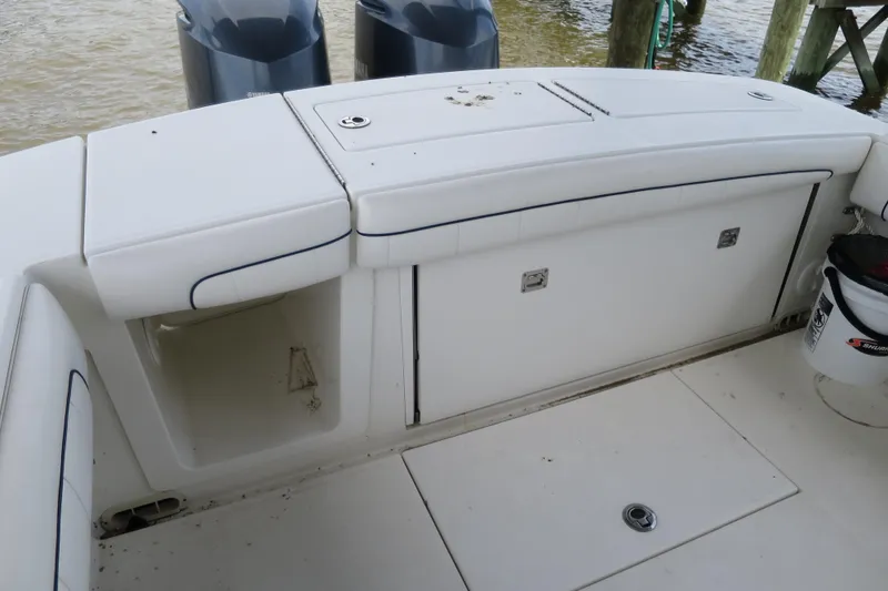 Slide: The Image of 2016 Regulator 28 boat deck with storage compartments and twin engines. - 6