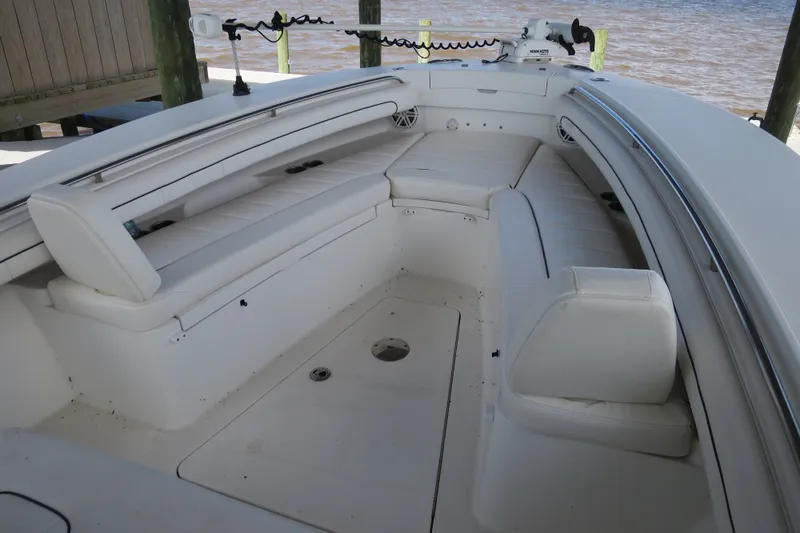 Slide: The Image of 2016 Regulator 28 boat interior with white seating and fishing equipment. - 20