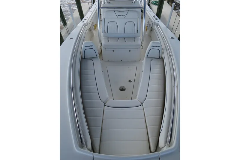 Slide: The Image of 2016 Regulator 28 boat interior with white cushioned seating and sleek design. - 21
