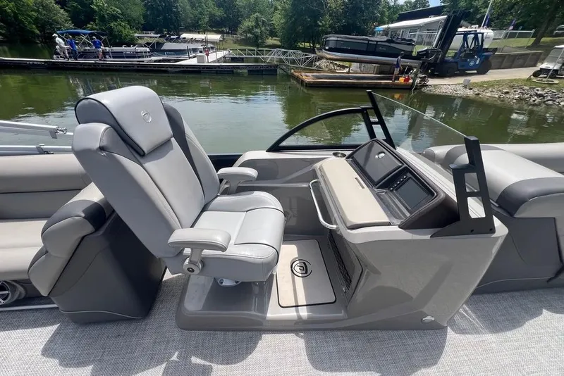 Slide: The Image of Captain's chair and helm of 2017 Premier 270 Super Sport boat by the water. - 9