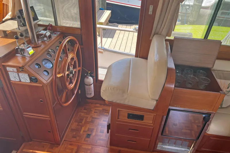 Slide: The Image of Interior helm of 1991 Grand Banks 42 Motoryacht with wooden steering wheel and controls. - 11