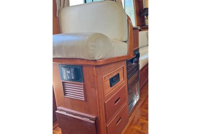 Slide: The Image of Interior of 1991 Grand Banks 42 Motoryacht with wooden cabinetry and cushioned seating. - 12