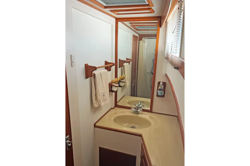 Slide: The Image of Bathroom interior of 1991 Grand Banks 42 Motoryacht with sink, mirror, and towel rack. - 17