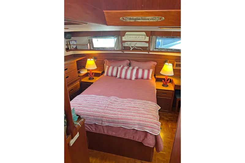 Slide: The Image of Cozy bedroom in 1991 Grand Banks 42 Motoryacht with striped bedding and warm lighting. - 18
