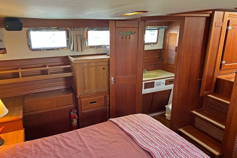 Slide: The Image of Interior of 1991 Grand Banks 42 Motoryacht with wood cabinetry and cozy sleeping area. - 19