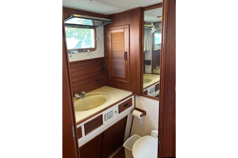 Slide: The Image of Bathroom interior of 1991 Grand Banks 42 Motoryacht with wooden cabinetry and sink. - 24