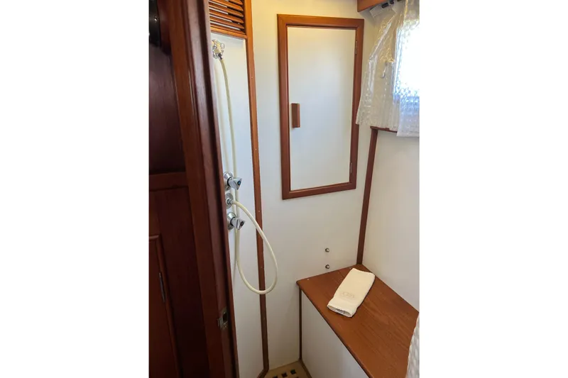 Slide: The Image of Shower area in 1991 Grand Banks 42 Motoryacht with wooden bench and mirror. - 25