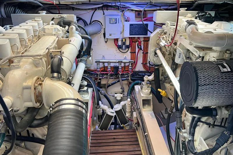 Slide: The Image of Engine room of a 1991 Grand Banks 42 Motoryacht, showcasing dual engines and mechanical components. - 26