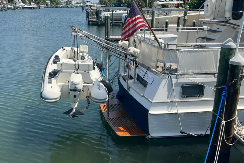 Slide: The Image of Grand Banks 42 Motoryacht (1991) docked with dinghy and American flag. - 31