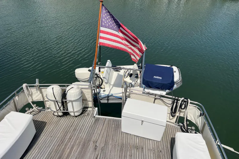 Slide: The Image of 1991 Grand Banks 42 Motoryacht deck with American flag and water view. - 32