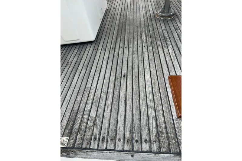 Slide: The Image of Teak deck of 1991 Grand Banks 42 Motoryacht, showcasing weathered wood texture. - 39