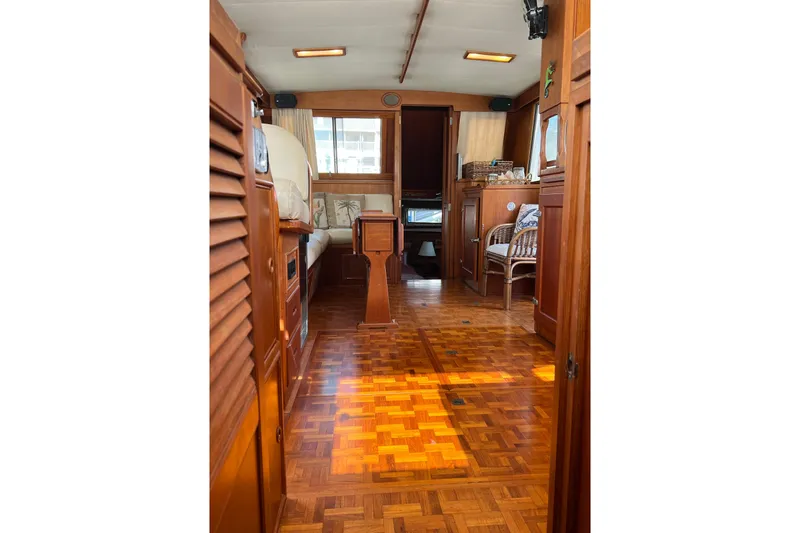 Slide: The Image of Interior of 1991 Grand Banks 42 Motoryacht with wooden flooring and cozy seating area. - 6