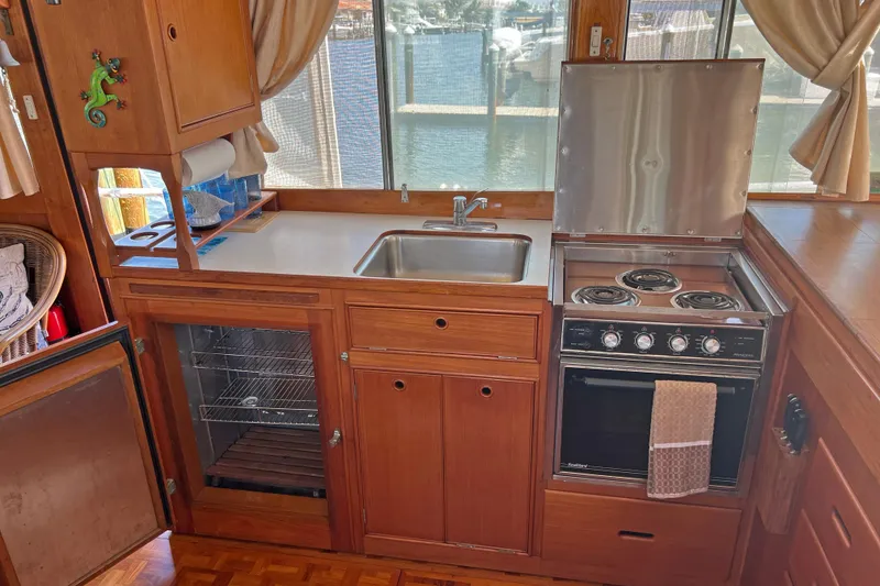 Slide: The Image of Galley kitchen in 1991 Grand Banks 42 Motoryacht with stove, sink, and wooden cabinetry. - 7