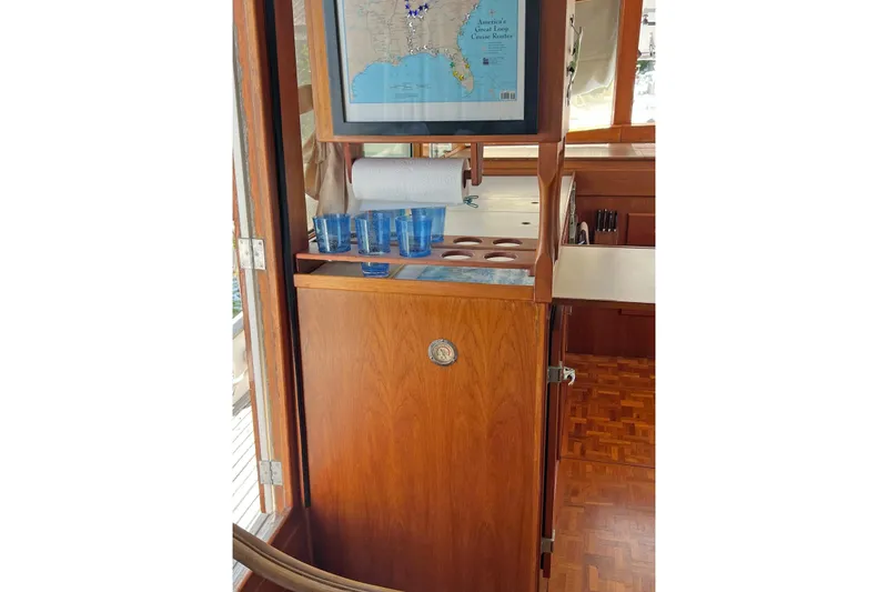 Slide: The Image of Interior of 1991 Grand Banks 42 Motoryacht with wooden cabinetry and nautical map. - 8