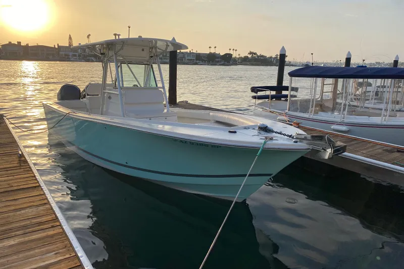 The Image of 2007 Regulator 26 Forward Seating boat docked at sunset, calm waters, scenic background. - 0