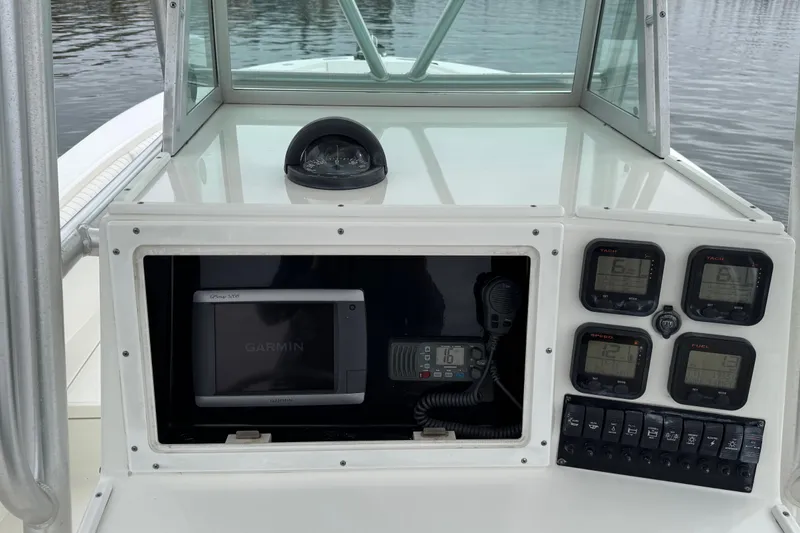 Slide: The Image of 2007 Regulator 26 Forward Seating boat dashboard with Garmin GPS and control gauges. - 11
