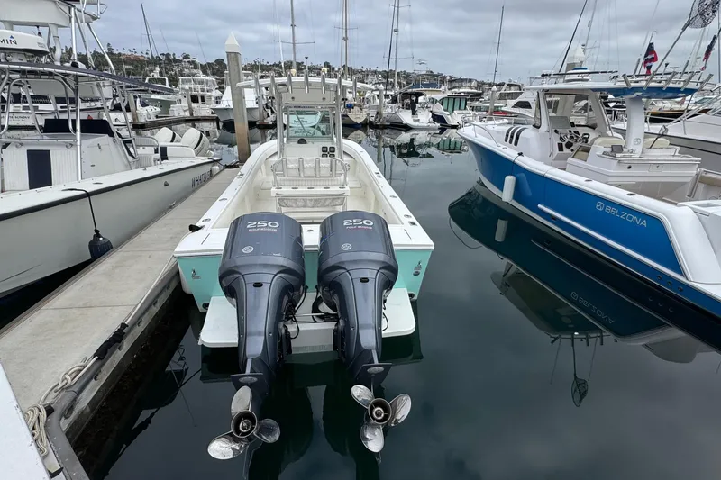 Slide: The Image of 2007 Regulator 26 Forward Seating boat docked with twin 250 horsepower engines. - 3