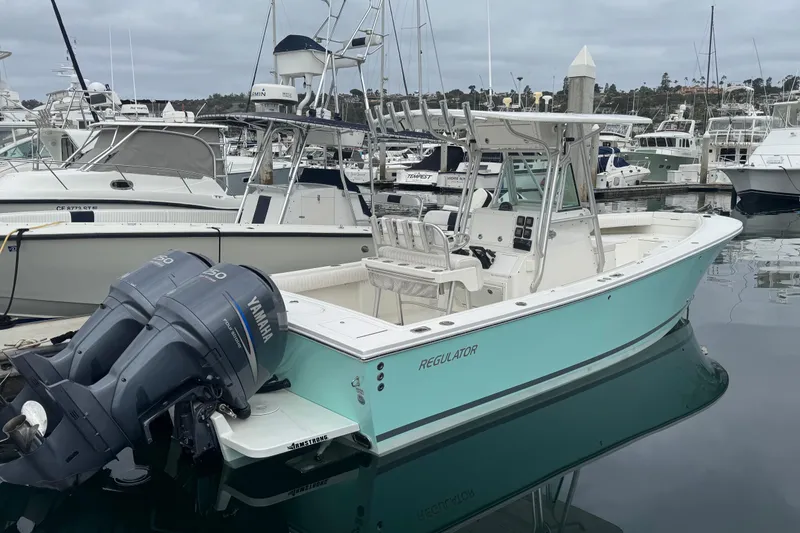 The Image of 2007 Regulator 26 Forward Seating boat docked with twin Yamaha engines. - 0