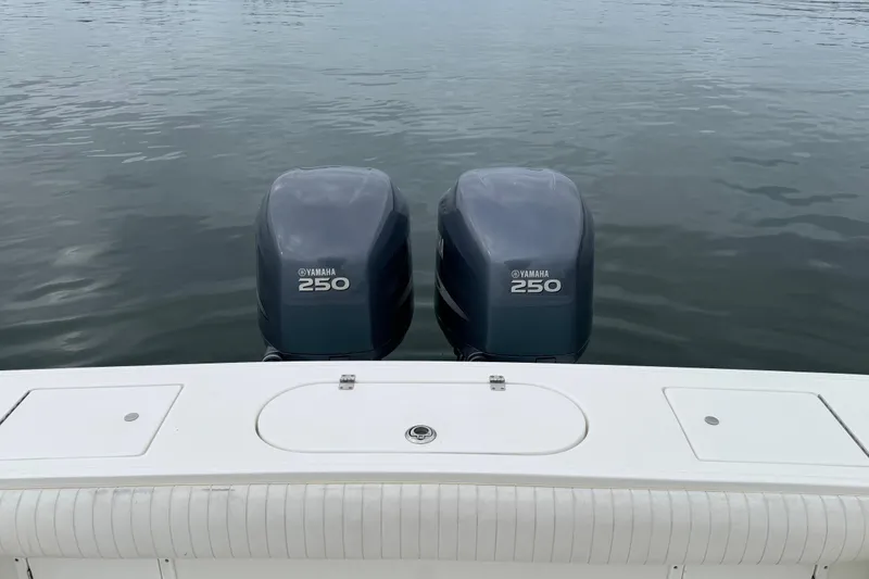 Slide: The Image of 2007 Regulator 26 Forward Seating boat with twin Yamaha 250 engines on calm water. - 9